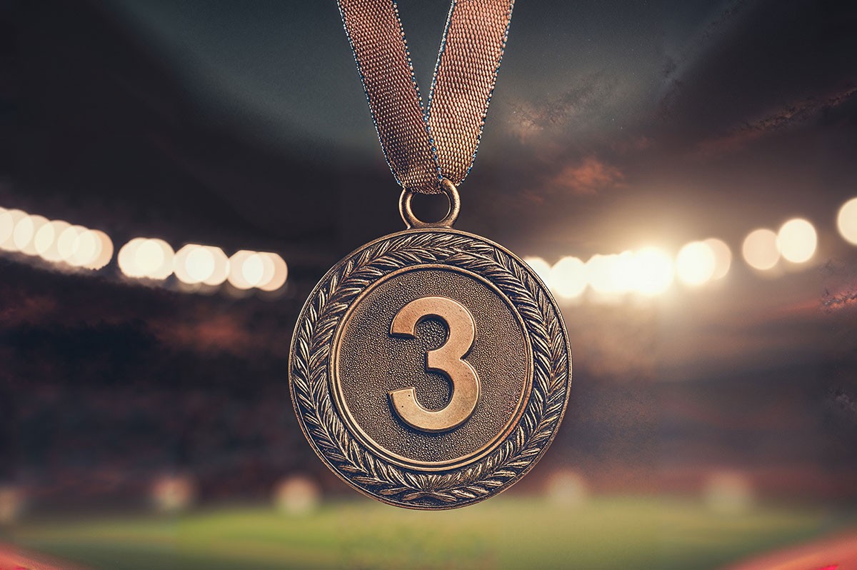 Die Zahl drei auf einer Medaille WestLotto Glückszahlen