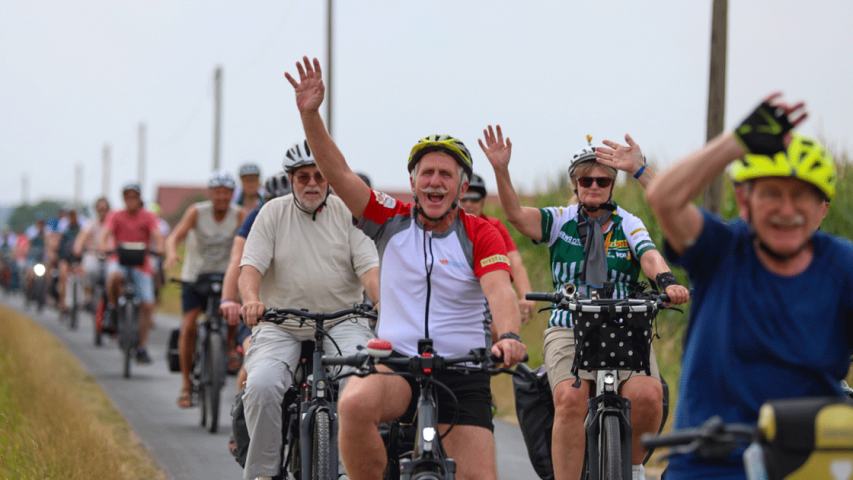 Eine Gruppe Radfahrer grüßt in die Kamera