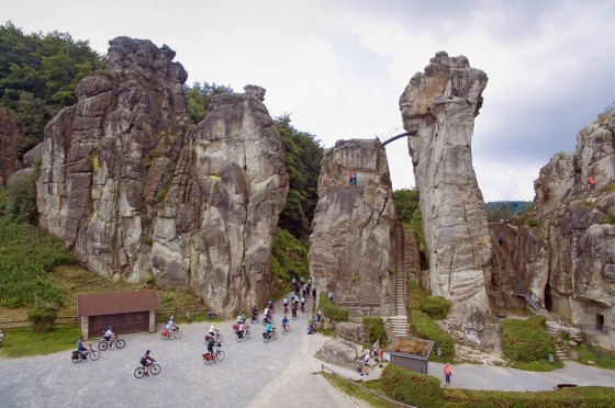 Mehrere Radfahrer fahren auf die Externsteine zu | WestLotto Radtour des Monats